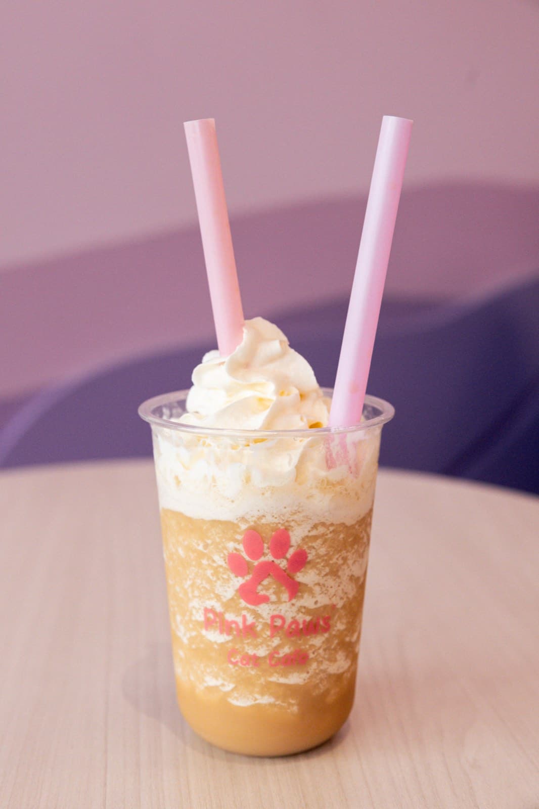 An iced Pink Paws drink topped with whipped cream