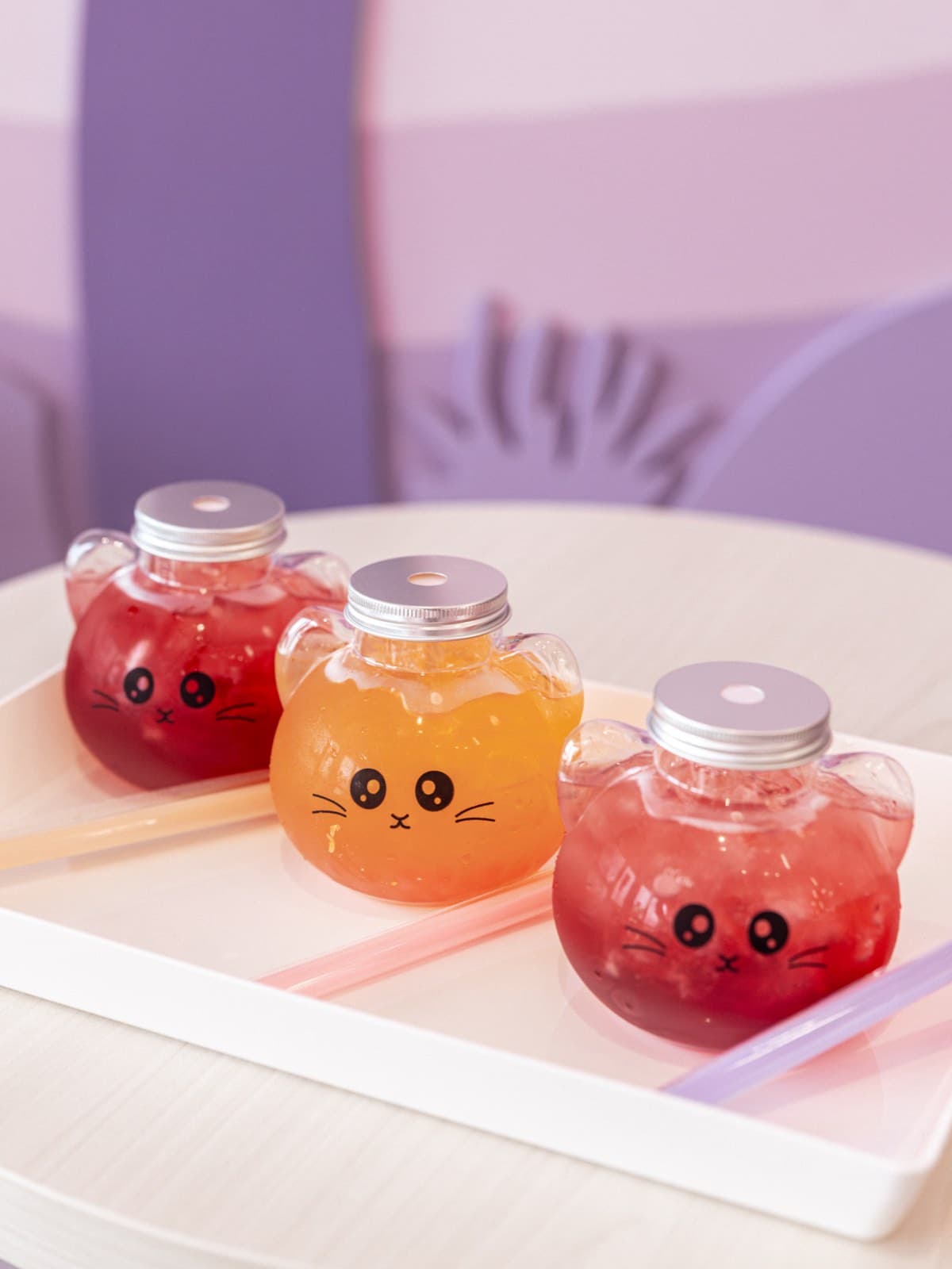 Cat-shaped bottles of juice on a tray in the café